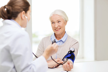 Image showing doctor with tonometer and senior woman at hospital