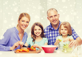 Image showing happy family with two kids making dinner at home