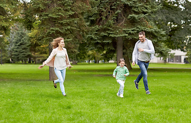 Image showing happy family walking in summer park