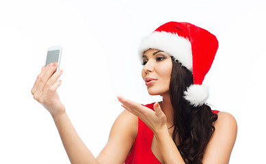 Image showing woman in santa hat taking selfie by smartphone