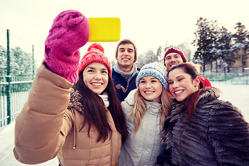 Image showing happy friends taking selfie with smartphone