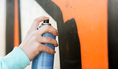 Image showing close up of hand drawing graffiti with spray paint