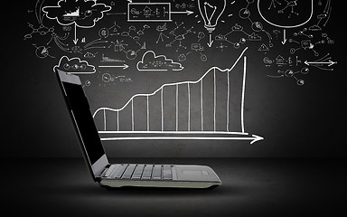 Image showing open laptop computer with scheme and chart doodles