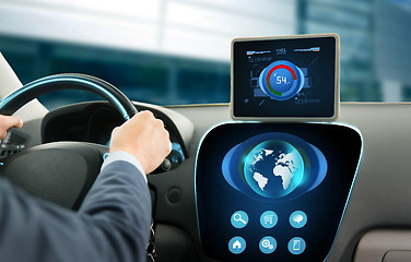 Image showing close up of businessman with tablet pc driving car