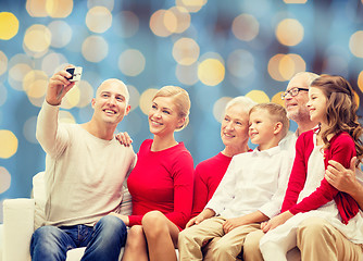 Image showing smiling family with camera