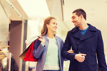 Image showing happy young couple with shopping bags in mall