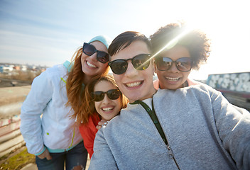 Image showing group of happy friends taking selfie on street