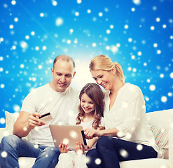 Image showing happy family with tablet pc and credit card