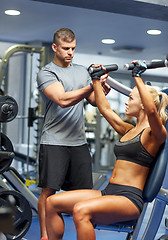 Image showing man and woman flexing muscles on gym machine