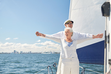 Image showing senior couple enjoying freedom on sail boat in sea