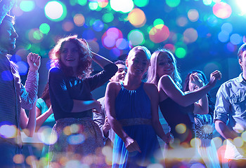 Image showing group of happy friends dancing in night club