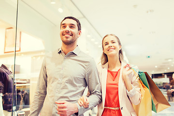 Image showing happy young couple with shopping bags in mall