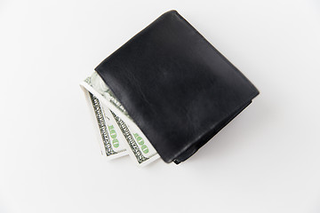 Image showing close up of dollar money in black wallet on table