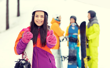 Image showing happy friends in helmets with snowboards