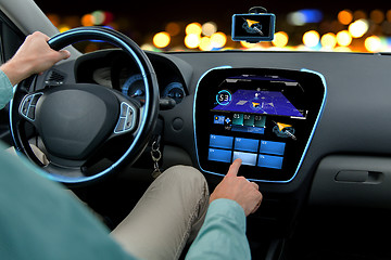 Image showing close up of man driving car with navigation system