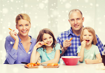 Image showing happy family with two kids making dinner at home