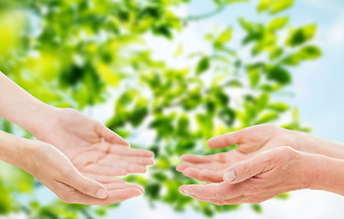 Image showing close up of senior and young woman hands