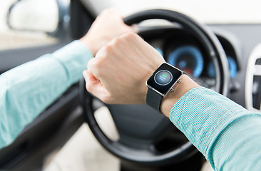 Image showing hands with starter icon on smartwatch driving car