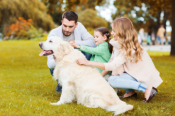 Image showing happy family with labrador retriever dog in park