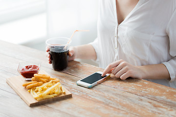 Image showing close up of woman with smart phone and fast food