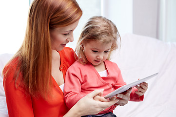 Image showing happy mother and daughter with tablet pc computer