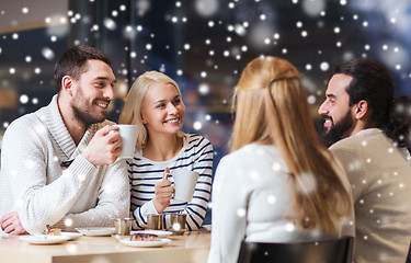 Image showing happy friends meeting and drinking tea or coffee