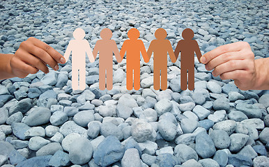 Image showing hands holding people pictogram over stone desert