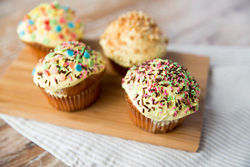 Image showing close up of glazed cupcakes or muffins on table