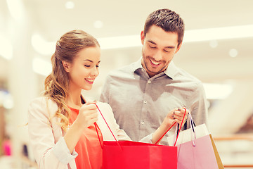 Image showing happy young couple with shopping bags in mall