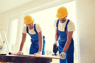 Image showing group of builders with tools indoors