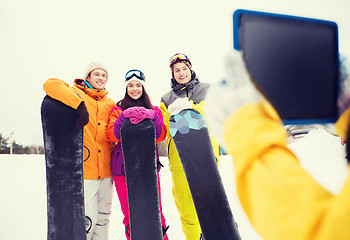 Image showing happy friends with snowboards and tablet pc