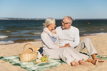 Image showing happy senior couple talking on summer beach