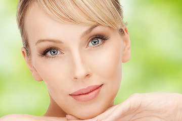 Image showing beautiful young woman face over green background