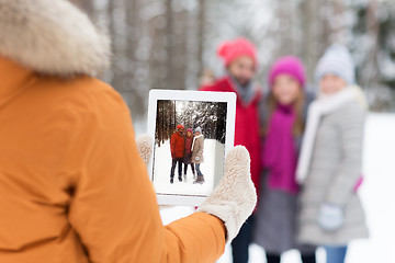 Image showing happy friends with tablet pc in winter forest