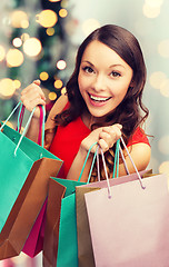 Image showing smiling woman with colorful shopping bags