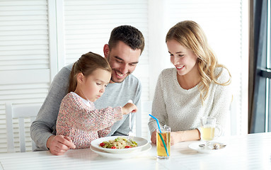 Image showing happy family having dinner at restaurant or cafe