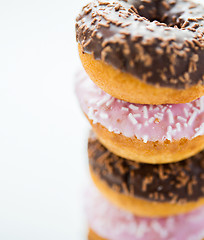 Image showing close up of glazed donuts pile over white