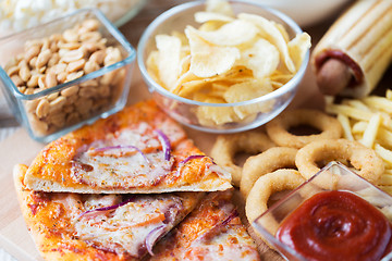Image showing close up of fast food snacks on wooden table