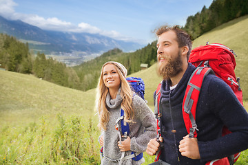 Image showing smiling couple with backpacks hiking