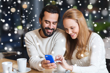 Image showing happy couple with smartphone  and coffee at cafe