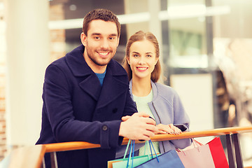 Image showing happy young couple with shopping bags in mall