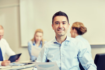 Image showing smiling group of businesspeople meeting in office