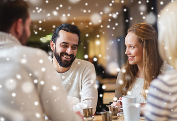 Image showing happy friends meeting and drinking tea or coffee