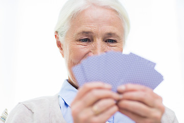 Image showing close up of happy senior woman playing cards