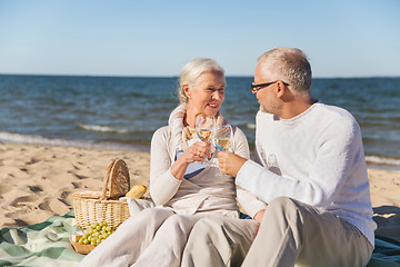 Image showing happy senior couple talking on summer beach