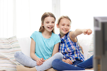 Image showing two happy little girls watching tv at home