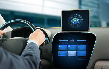 Image showing close up of man with tablet pc driving car