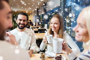 Image showing happy friends meeting and drinking tea or coffee