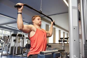 Image showing man flexing muscles on cable machine gym