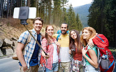 Image showing friends with backpack taking selfie by smartphone